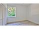 Bright bedroom featuring wood-look tile flooring, a window, and a closet at 1350 Scarlett Trl, New Smyrna Beach, FL 32168