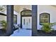 Inviting front entryway with elegant double doors, black accents, pendant lighting, and verdant plants at 1350 Scarlett Trl, New Smyrna Beach, FL 32168