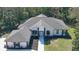 Stunning exterior of a white home with black accents, well-maintained landscaping, and gray roof at 1350 Scarlett Trl, New Smyrna Beach, FL 32168