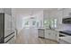 Open concept kitchen with white cabinetry, quartz countertops, and modern appliances at 1350 Scarlett Trl, New Smyrna Beach, FL 32168