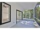 Screened-in lanai with view of tropical landscaping and access to the bedroom at 1350 Scarlett Trl, New Smyrna Beach, FL 32168