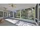 Spacious screened-in lanai with a view of tropical landscaping and multiple ceiling fans for comfortable outdoor living at 1350 Scarlett Trl, New Smyrna Beach, FL 32168