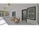 Screened-in lanai with comfortable seating and access to the backyard and Primary bathroom at 1350 Scarlett Trl, New Smyrna Beach, FL 32168