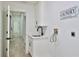 Convenient laundry room with sink, cabinet space, and white 'Laundry' wall decor at 1350 Scarlett Trl, New Smyrna Beach, FL 32168