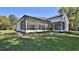 Spacious screened in back porch with ceiling fans and lawn area at 1350 Scarlett Trl, New Smyrna Beach, FL 32168