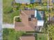 Aerial view showcasing a home's backyard pool, lush landscaping, and outdoor living space surrounded by green lawns at 15 Katrinas Dr, Ormond Beach, FL 32174