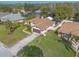 Aerial view of the home showcasing the driveway, lawn, mature trees and screened-in patio at 15 Katrinas Dr, Ormond Beach, FL 32174