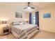 Bedroom with carpet, bed, side tables, lamps, ceiling fan and a blue and white striped comforter at 15 Katrinas Dr, Ormond Beach, FL 32174