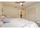 Comfortable bedroom featuring a ceiling fan, closet, carpet, and a plush bed with floral comforter at 15 Katrinas Dr, Ormond Beach, FL 32174