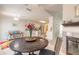 Open-concept dining area adjacent to the kitchen, featuring tile flooring and a fireplace at 15 Katrinas Dr, Ormond Beach, FL 32174