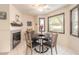 Charming dining area with a modern table, tile floors, and a view of the fireplace at 15 Katrinas Dr, Ormond Beach, FL 32174