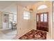 Welcoming foyer features tile flooring and a beautiful wood door, leading to a dining area and bright interiors at 15 Katrinas Dr, Ormond Beach, FL 32174