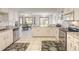 Bright kitchen with stainless steel appliances, white cabinets, granite countertops, and adjacent dining area at 15 Katrinas Dr, Ormond Beach, FL 32174
