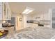 Bright kitchen with granite countertops, white cabinets, and stainless steel appliances at 15 Katrinas Dr, Ormond Beach, FL 32174