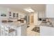 Well-lit kitchen features white cabinetry, stainless steel appliances, and a breakfast bar at 15 Katrinas Dr, Ormond Beach, FL 32174