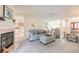 Cozy living room with fireplace, plush seating, and open access to the kitchen at 15 Katrinas Dr, Ormond Beach, FL 32174