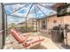 Relaxing screened-in patio with lounge chairs, a grill, and ample space for outdoor enjoyment at 15 Katrinas Dr, Ormond Beach, FL 32174