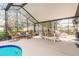 Spacious screened-in patio with comfortable seating and a dining area, perfect for entertaining at 15 Katrinas Dr, Ormond Beach, FL 32174