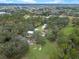 An aerial view shows the home is surrounded by mature trees on large acreage at 1715 Fern Park Dr, Port Orange, FL 32128