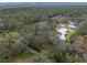 Expansive property with mature trees, home, guest house, pool, and pasture, set against a backdrop of a lush forest at 1715 Fern Park Dr, Port Orange, FL 32128