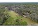 An aerial view shows the pastures, trees, and home site on the horse property at 1715 Fern Park Dr, Port Orange, FL 32128