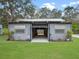 A well-maintained barn featuring an open design, set against a backdrop of a lush green field at 1715 Fern Park Dr, Port Orange, FL 32128