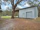 A spacious barn with an overhang offering versatile space for storage and covered parking on a grassy lot at 1715 Fern Park Dr, Port Orange, FL 32128
