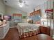 Comfortable bedroom with floral bedding, ample natural light, and charming decor at 1715 Fern Park Dr, Port Orange, FL 32128