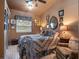 Bedroom with warm lighting, decorative mirrors, and a cozy armchair in the corner at 1715 Fern Park Dr, Port Orange, FL 32128
