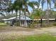 Charming home with a spacious yard, beautiful palm trees, and well-maintained landscaping at 1715 Fern Park Dr, Port Orange, FL 32128