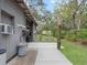 Exterior of a metal building featuring an adjacent concrete pad, roll up doors, and mature landscaping at 1715 Fern Park Dr, Port Orange, FL 32128
