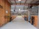 A horse barn interior featuring multiple stalls with metal bars and a concrete floor at 1715 Fern Park Dr, Port Orange, FL 32128