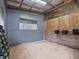 A horse stall featuring wood paneling, a hay rack, and a window for ventilation at 1715 Fern Park Dr, Port Orange, FL 32128