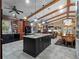 Bright, open kitchen with a large island, wooden beams, and dark cabinetry offers a perfect space for entertaining at 1715 Fern Park Dr, Port Orange, FL 32128