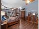 Cozy primary bedroom features a fireplace, stylish furnishings, and wood-look flooring at 1715 Fern Park Dr, Port Orange, FL 32128