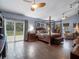 An ample bedroom offers wood-look floors, outdoor views, and fan at 1715 Fern Park Dr, Port Orange, FL 32128
