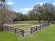 A fenced paddock for horses is featured with ample room for training and riding at 1715 Fern Park Dr, Port Orange, FL 32128