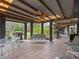 A covered patio features tile flooring, ceiling fan, and outdoor furniture, creating an ideal space for relaxation at 1715 Fern Park Dr, Port Orange, FL 32128