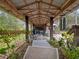 View of the covered patio, showcasing the open design, wooden beams, and view to the property at 1715 Fern Park Dr, Port Orange, FL 32128