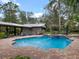 Spacious backyard featuring a pool, spa, and covered outdoor seating area, perfect for entertaining at 1715 Fern Park Dr, Port Orange, FL 32128