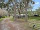 Large lot with mature trees, fenced pasture, and long driveway to the house at 1715 Fern Park Dr, Port Orange, FL 32128