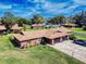 Aerial view of a charming duplex with spacious lawns, a long driveway, and well-maintained landscaping, perfect for community living at 1818 Enterprise Ave # B, New Smyrna Beach, FL 32168