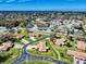 Wide aerial shot of a community featuring single-Gathering homes and lush greenery at 1818 Enterprise Ave # B, New Smyrna Beach, FL 32168