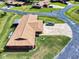 Aerial view highlighting a well-maintained home with a backyard and long driveway in a serene community setting at 1818 Enterprise Ave # B, New Smyrna Beach, FL 32168