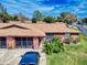 Aerial view of a duplex with a spacious driveway, neat landscaping, and a well-maintained exterior, perfect for easy living at 1818 Enterprise Ave # B, New Smyrna Beach, FL 32168