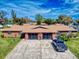 Aerial view showcasing a well-kept duplex with lush lawns, ample parking, and convenient community living at 1818 Enterprise Ave # B, New Smyrna Beach, FL 32168