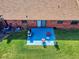 A vibrant blue back patio with seating and grill, perfect for outdoor entertaining and relaxation at 1818 Enterprise Ave # B, New Smyrna Beach, FL 32168