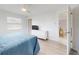 Bedroom with wood-look flooring, TV, dresser, and access to an attached room at 1818 Enterprise Ave # B, New Smyrna Beach, FL 32168