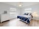 Bright bedroom with white walls, wood-look flooring and a comfortable bed at 1818 Enterprise Ave # B, New Smyrna Beach, FL 32168