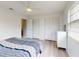 Cozy bedroom featuring white walls, wood-look flooring and ample closet space at 1818 Enterprise Ave # B, New Smyrna Beach, FL 32168